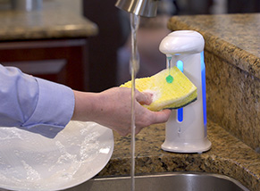 Image of a persons hand with a sponge in it getting soap out of Sonic Soap
